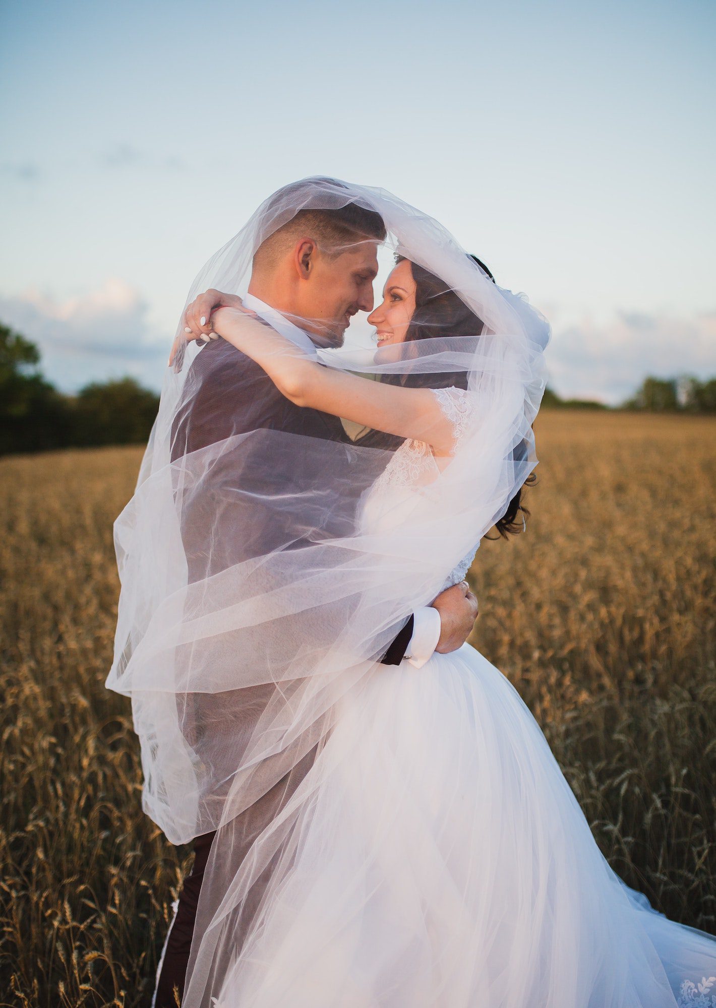 wedding couple embrace whilst being filmed by low cost wedding videographer